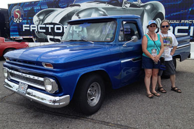 Nicky Lynn (right) and Rose Moss (left) stand proudly next to their flamed, blue 1964 Chevy C-10 pickup.  The Neosho, Missouri-based pair enjoy using the truck for many purposes, with car shows and driving tours among their favorite activities.